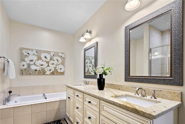 full bath featuring a garden tub, a sink, a shower stall, and double vanity