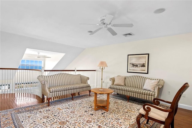 living room with baseboards, visible vents, ceiling fan, wood finished floors, and vaulted ceiling