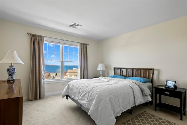 bedroom with carpet, visible vents, and baseboards