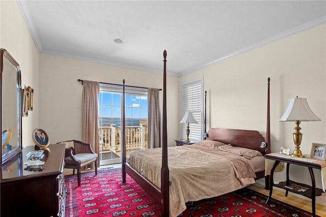 bedroom featuring ornamental molding, access to outside, and wood finished floors