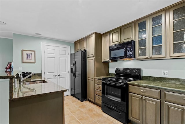 kitchen featuring glass insert cabinets, dark stone countertops, black appliances, a sink, and light tile patterned flooring