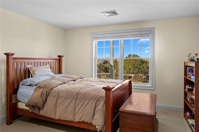 carpeted bedroom with visible vents and baseboards