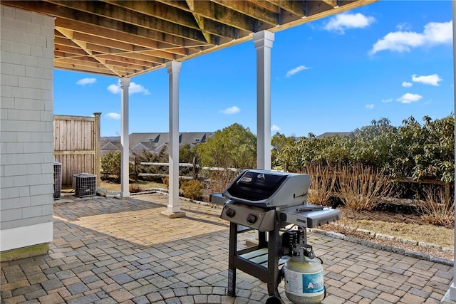 view of patio / terrace with a grill and fence