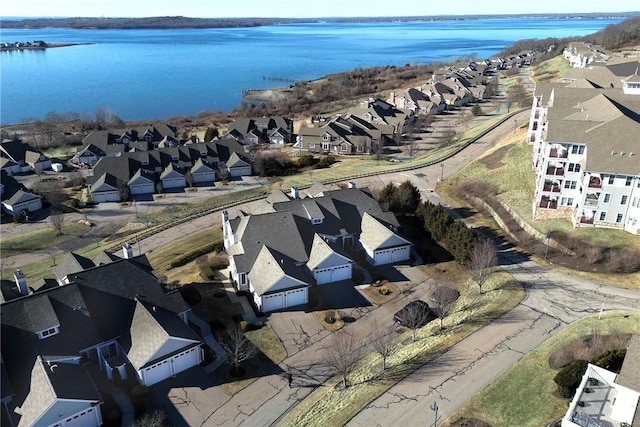bird's eye view with a residential view and a water view