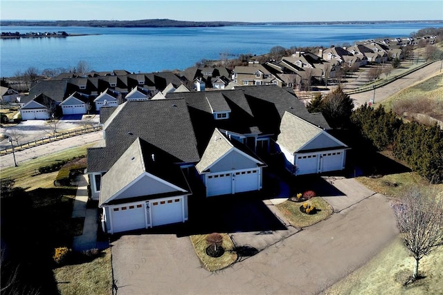 birds eye view of property with a water view and a residential view