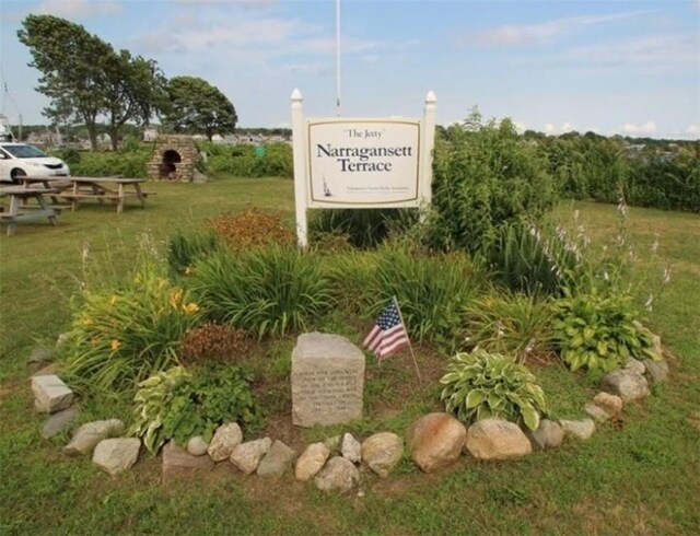 community sign featuring a lawn