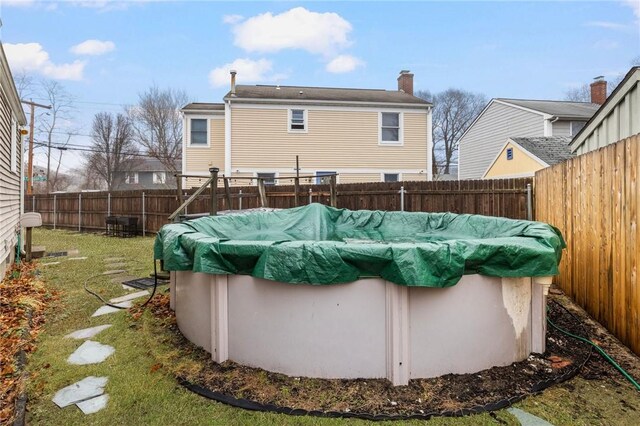 view of swimming pool with a fenced in pool, a yard, and a fenced backyard