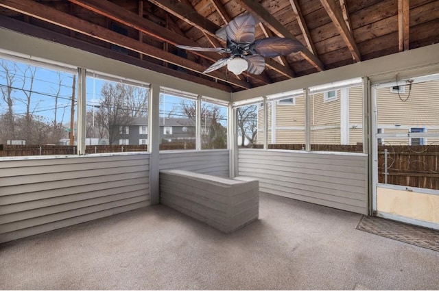 unfurnished sunroom with wood ceiling, ceiling fan, and vaulted ceiling