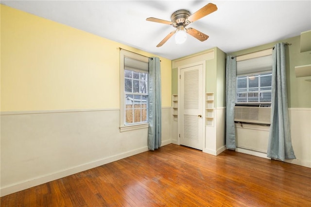 unfurnished bedroom featuring ceiling fan, baseboards, and wood finished floors