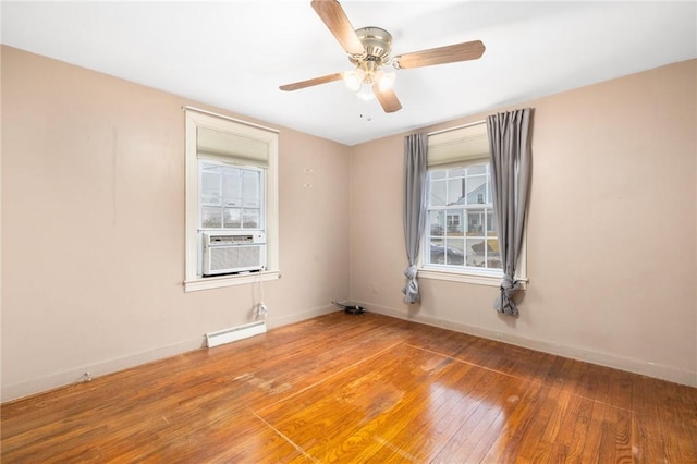 empty room featuring cooling unit, baseboards, ceiling fan, hardwood / wood-style flooring, and a baseboard heating unit