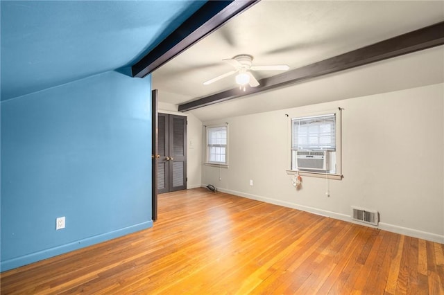 unfurnished room with a ceiling fan, baseboards, visible vents, lofted ceiling with beams, and light wood-style flooring