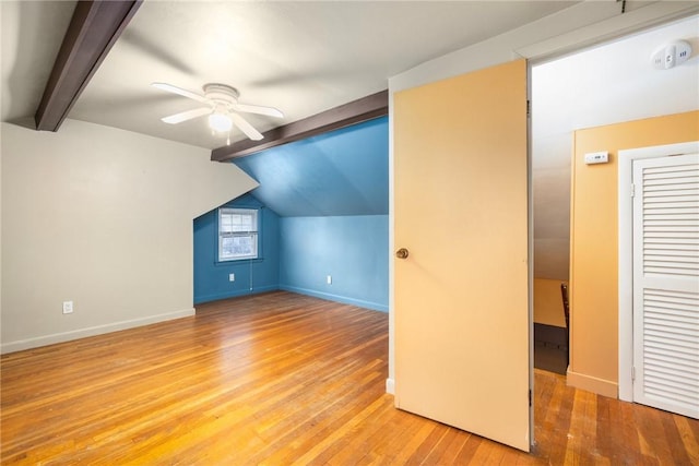 bonus room featuring vaulted ceiling with beams, a ceiling fan, light wood-type flooring, and baseboards