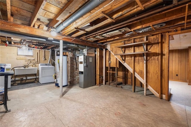 unfinished below grade area with heating unit, washer / dryer, gas water heater, and a sink