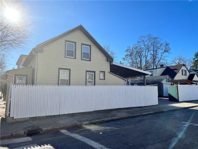 view of side of property featuring fence