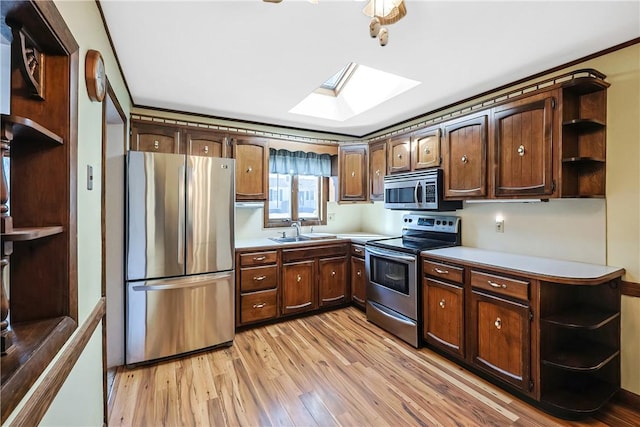 kitchen with light wood finished floors, appliances with stainless steel finishes, and open shelves