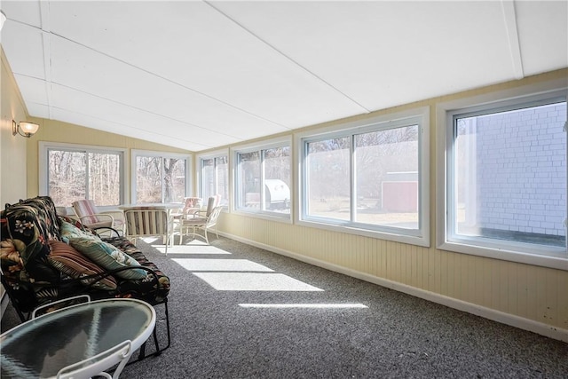 unfurnished sunroom featuring vaulted ceiling