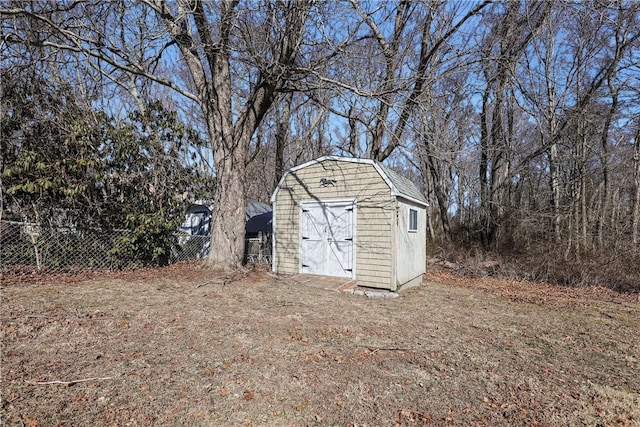 view of shed featuring fence