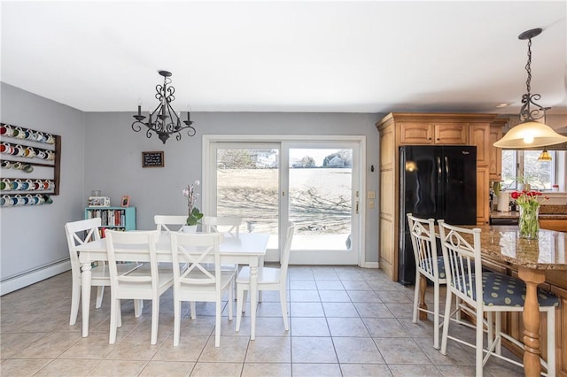 dining space featuring a notable chandelier and light tile patterned flooring