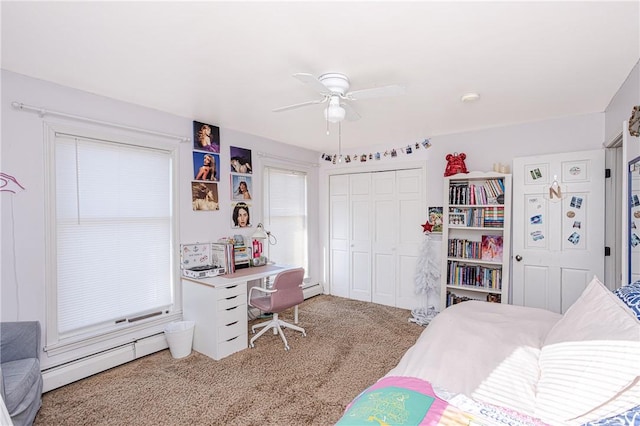 bedroom featuring carpet floors, a closet, baseboard heating, a baseboard heating unit, and a ceiling fan