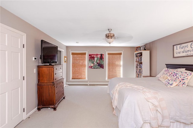 bedroom featuring a ceiling fan, a baseboard radiator, carpet flooring, and baseboards