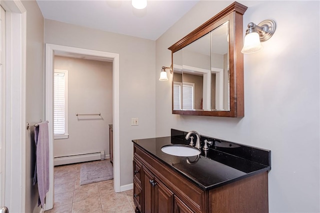 bathroom featuring tile patterned floors, baseboards, baseboard heating, and vanity