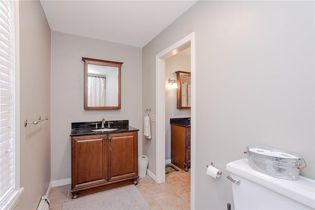 full bathroom featuring toilet, tile patterned flooring, baseboards, and vanity