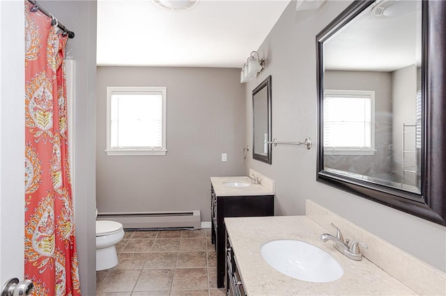 full bathroom with toilet, baseboard heating, a wealth of natural light, and vanity