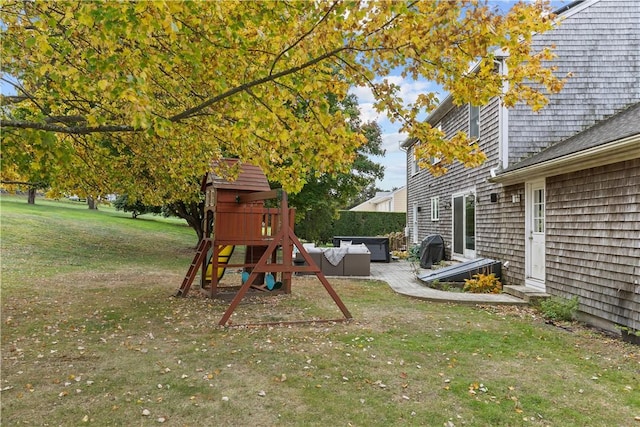 view of jungle gym with a yard, a patio, and outdoor lounge area