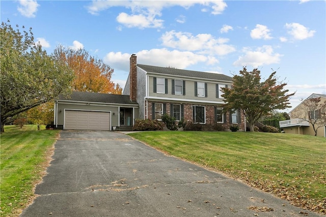 view of front of home featuring driveway, a chimney, an attached garage, a front lawn, and brick siding