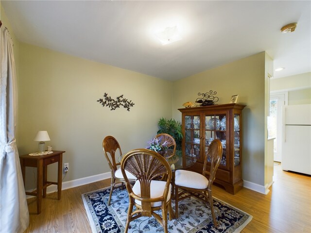 dining space with wood finished floors and baseboards