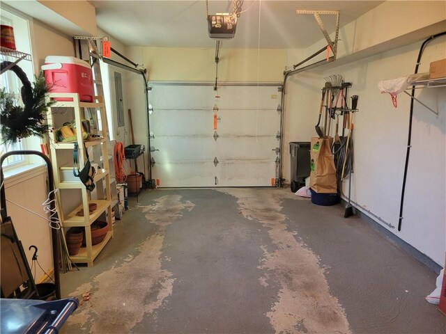 garage with a garage door opener and electric panel