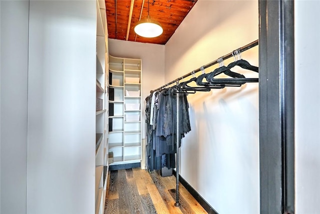 spacious closet featuring lofted ceiling and wood finished floors