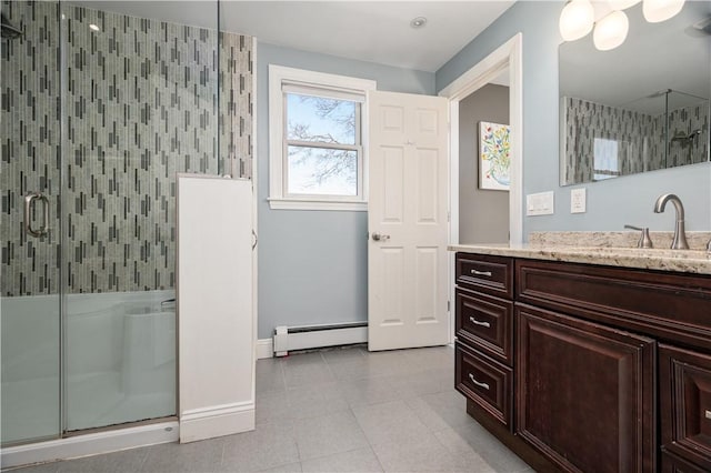 full bath with baseboards, tile patterned floors, vanity, a shower stall, and a baseboard heating unit