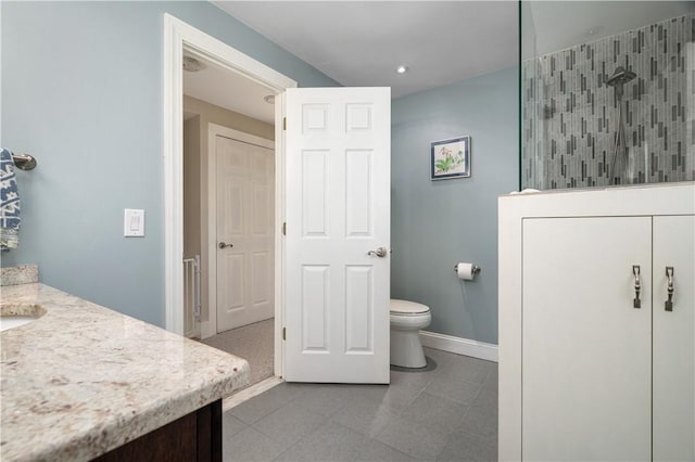 full bathroom featuring toilet, tile patterned floors, a walk in shower, and vanity