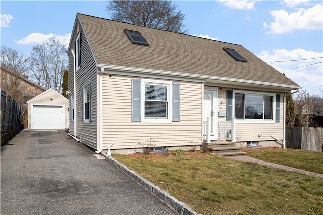 view of front of property with an outbuilding, a shingled roof, fence, a garage, and driveway