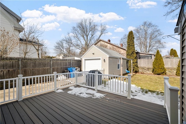 wooden terrace with a yard, an outbuilding, a fenced backyard, and a detached garage