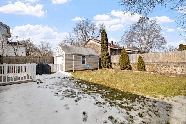 exterior space featuring a detached garage, fence, and an outdoor structure