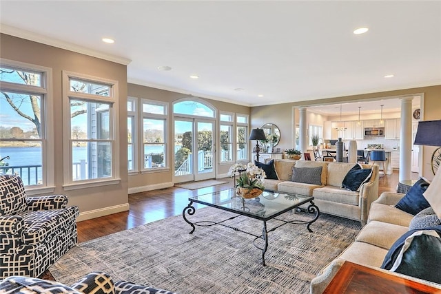 living room featuring crown molding, baseboards, wood finished floors, and recessed lighting