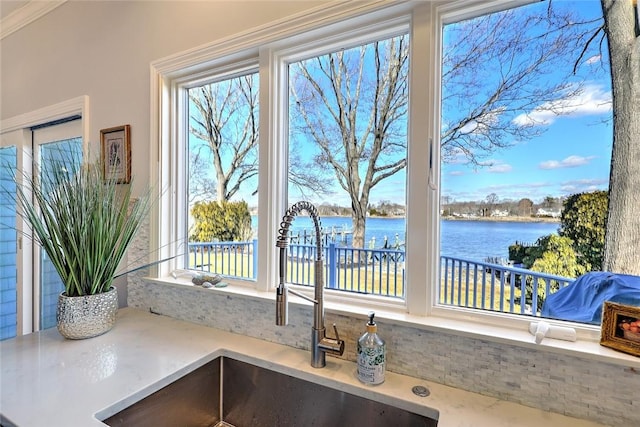 interior details featuring a water view and a sink