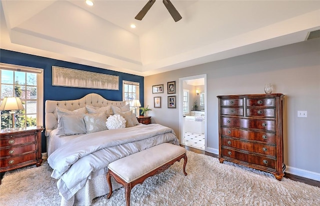 bedroom featuring recessed lighting, multiple windows, baseboards, and ensuite bathroom