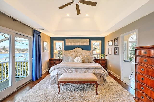 bedroom featuring visible vents, ceiling fan, wood finished floors, access to outside, and baseboards