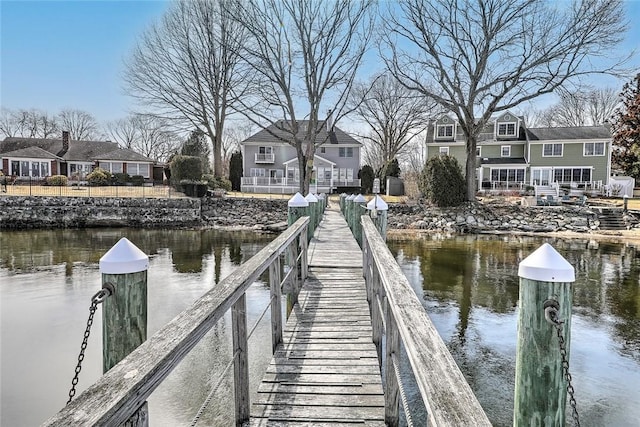 dock area featuring a water view and a residential view