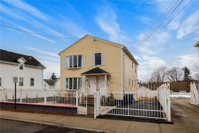 view of front of home featuring a fenced front yard and a gate