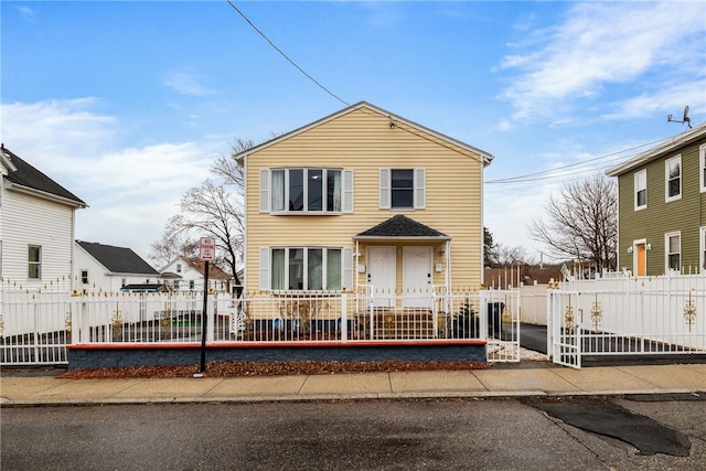 traditional-style home featuring a fenced front yard