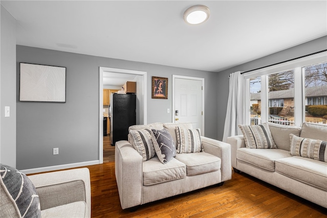 living room featuring wood finished floors and baseboards