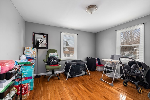 office space with light wood-type flooring and baseboards