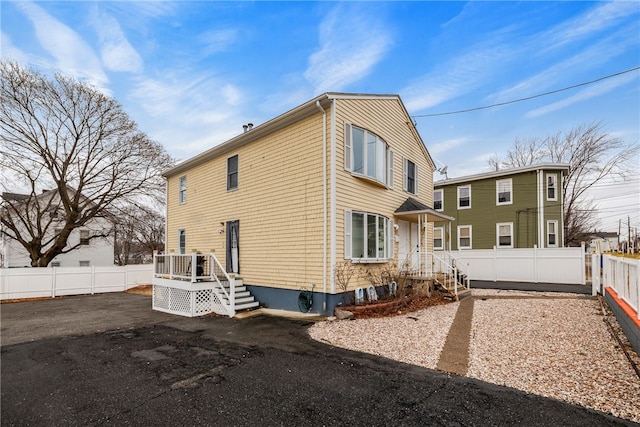 back of house featuring fence private yard and a wooden deck