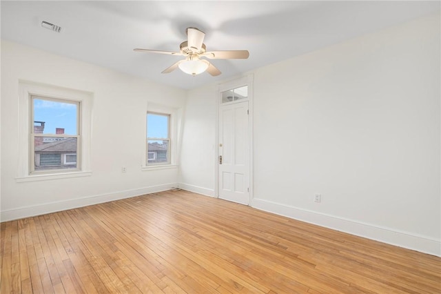 unfurnished room featuring visible vents, ceiling fan, light wood-style flooring, and baseboards