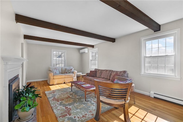 living area with baseboards, wood finished floors, a wall mounted air conditioner, a fireplace, and a baseboard heating unit