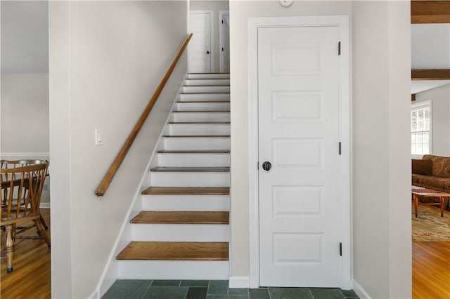 stairway with baseboards and wood finished floors